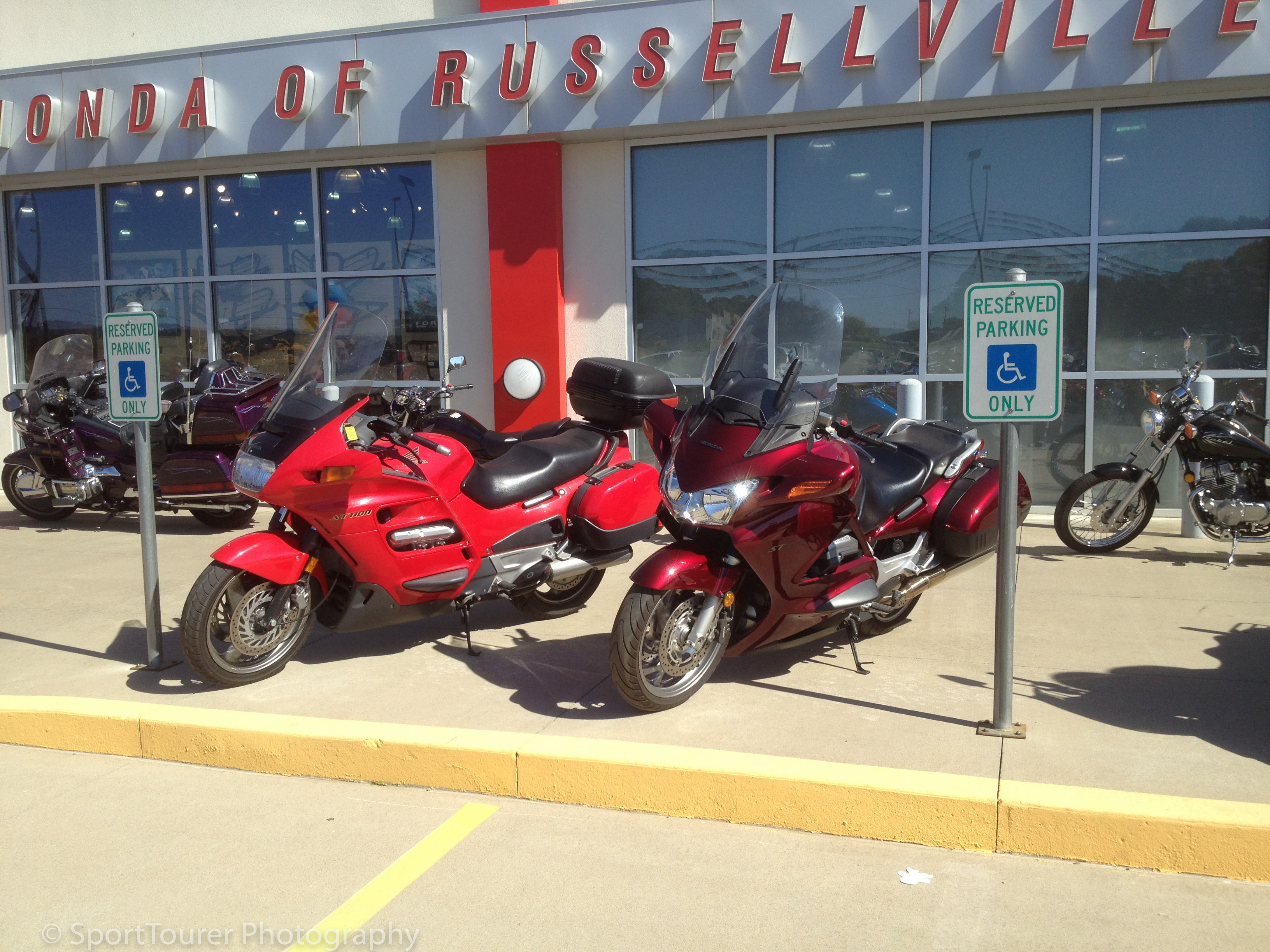  Arriving at the Russelville Honda Dealership, why am I not surprised to see which machines have been chosen and showcased to meet and greet you upon arrival? On the left, a Honda ST1100 and on the right, a Honda ST1300 