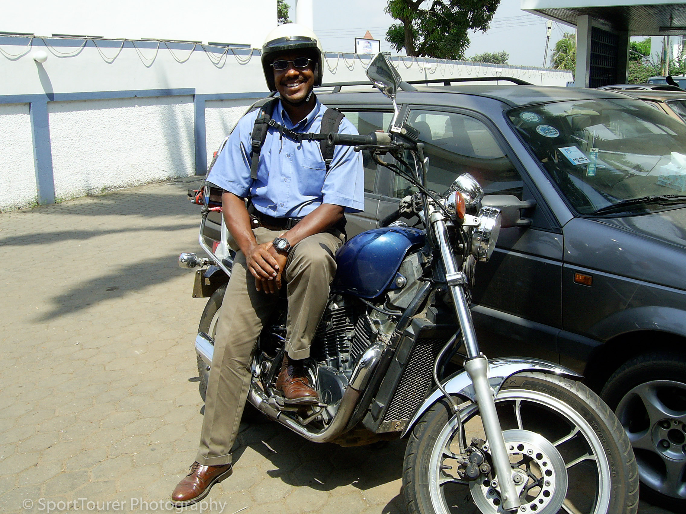 Sitting on 1983 Honda VT750c Shadow motorcycle in Ghana W.Africa